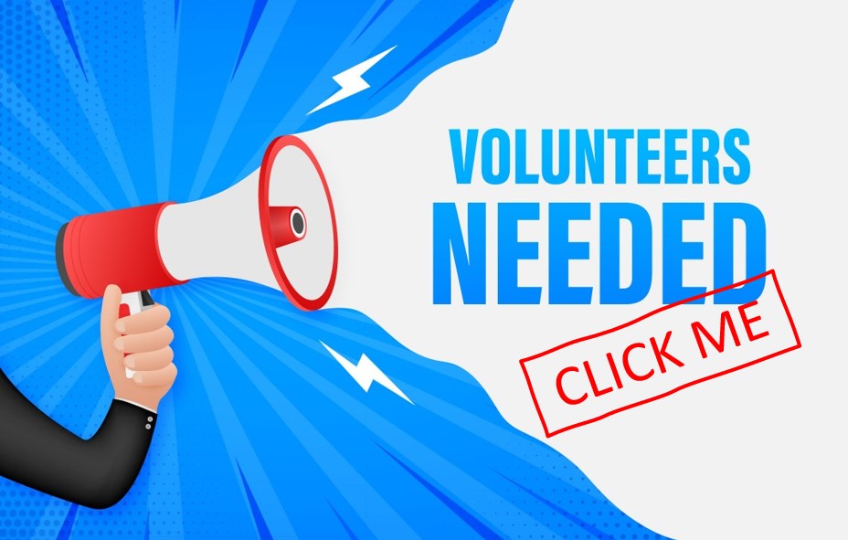 Image displays a hand holding a megaphone with the text saying "Volunteers Needed". 